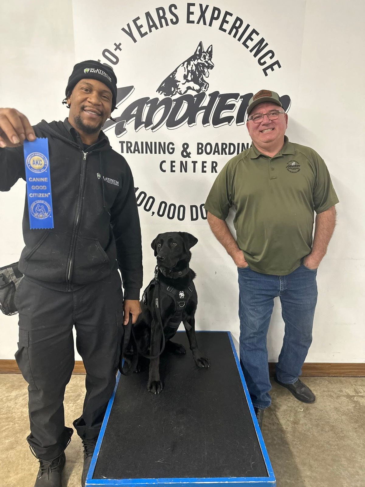 Two Platinum Pest Solutions team members with one of the company's detection dogs at a training session
